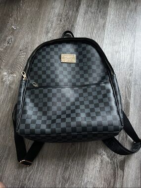 Louis Vuitton black monogram design with golden LV pin